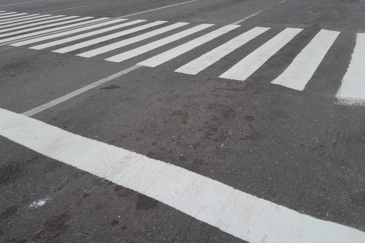 An empty road marked with a pedestrian crossing