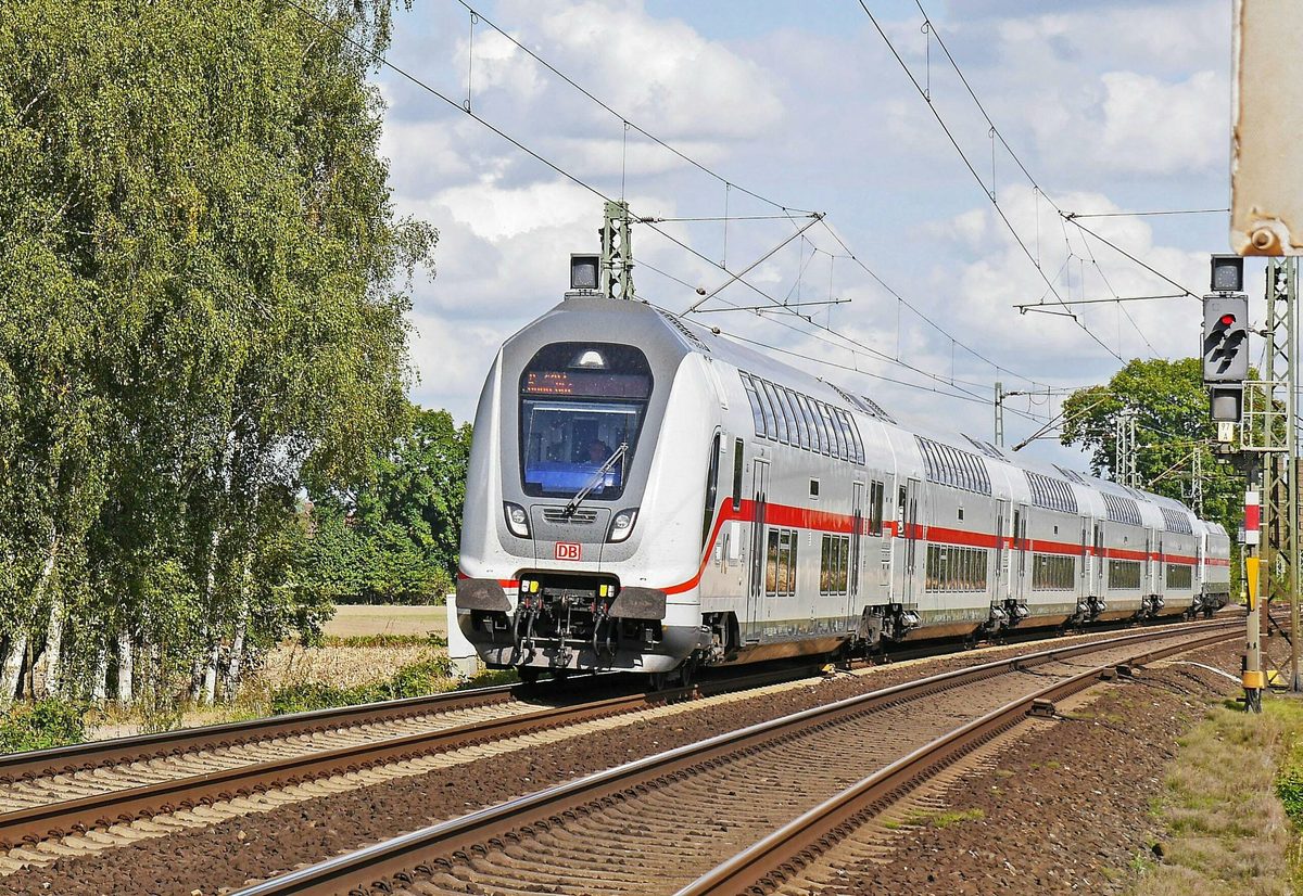 A passenger train travelling on open track