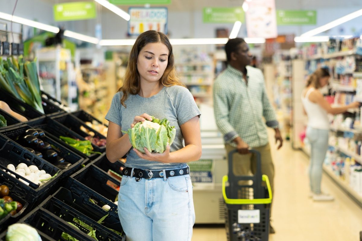 Shoppers in the produce aisle of a supermarket